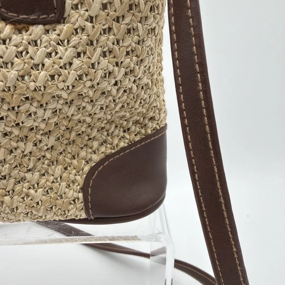Rosetti straw tote handbag with brown faux leather trim‎ and top handles.